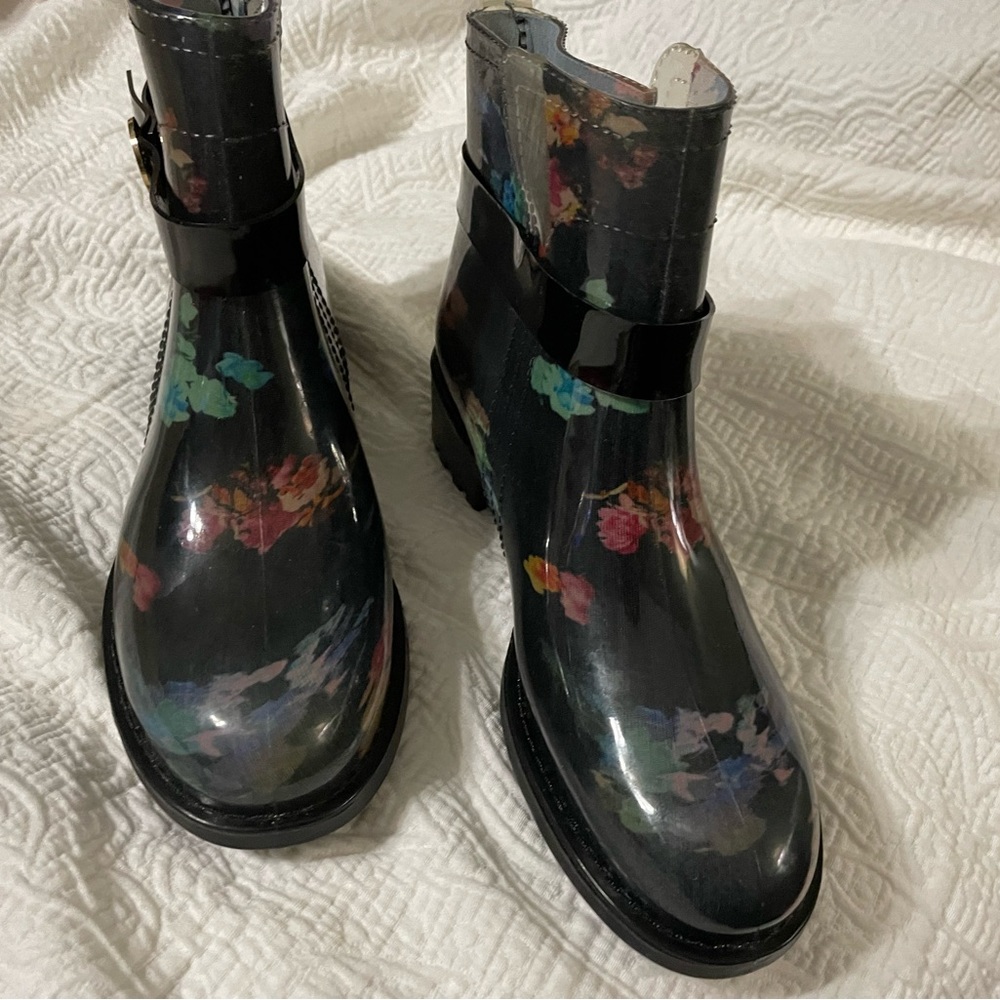 Black rain boots with floral multi color design.